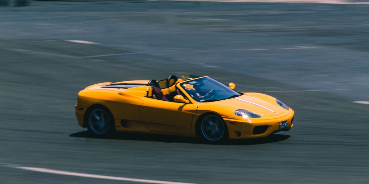 A Vibrant Yellow Convertible Sports Car Speeding jigsaw puzzle