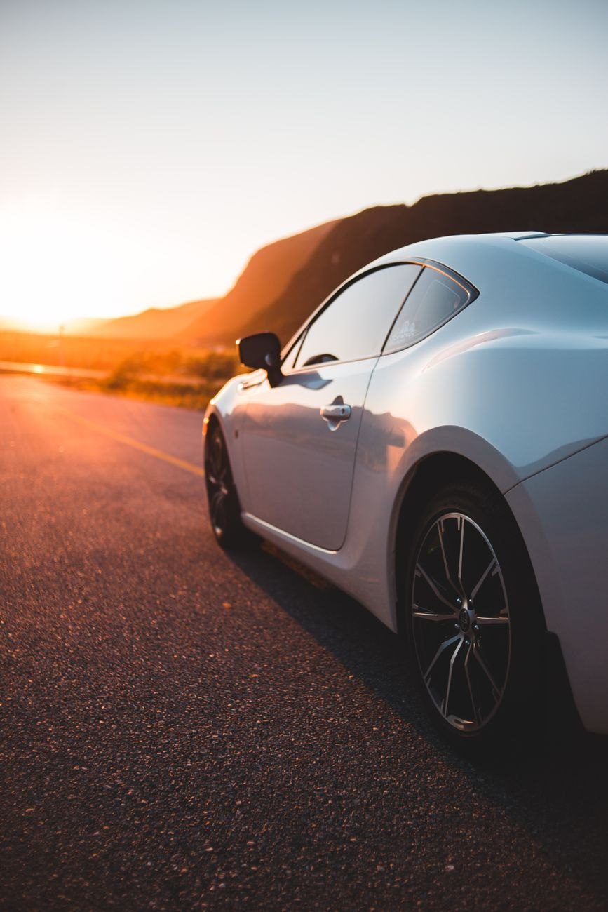 Shiny White Coupe Automobile on Paved Route jigsaw puzzle